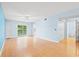 Light-filled living room featuring hardwood floors, balcony and entry to bathroom at 6016 Dick Pond Rd. # 109, Myrtle Beach, SC 29588