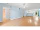 Well-lit living room with open layout and hardwood floors, leading to kitchen and balcony at 6016 Dick Pond Rd. # 109, Myrtle Beach, SC 29588