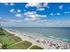 Beautiful beach view showcasing the shoreline, ocean, and blue sky dotted with clouds at 603 S Ocean Blvd. # 1205, North Myrtle Beach, SC 29582