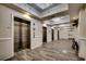 Hallway featuring multiple elevators and decorative chandeliers in the well-maintained building at 603 S Ocean Blvd. # 1205, North Myrtle Beach, SC 29582