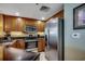 Kitchen featuring stainless steel refrigerator, built-in microwave and oven, and wood cabinetry at 603 S Ocean Blvd. # 1205, North Myrtle Beach, SC 29582