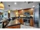 Well-lit kitchen featuring granite countertops, stainless steel appliances, and updated cabinets at 603 S Ocean Blvd. # 1205, North Myrtle Beach, SC 29582