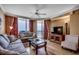 Relaxing living room featuring a comfortable sofa, television, and access to the balcony with ocean views at 603 S Ocean Blvd. # 1205, North Myrtle Beach, SC 29582