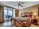 Comfortable main bedroom with balcony access and ocean views, hardwood floors and stylish decor at 603 S Ocean Blvd. # 1205, North Myrtle Beach, SC 29582