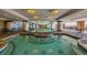 Inviting indoor pool area with columns, a hot tub, and plenty of lounge seating at 603 S Ocean Blvd. # 1205, North Myrtle Beach, SC 29582