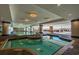 Indoor pool with ample lighting and surrounding columns, featuring a connecting hot tub at 603 S Ocean Blvd. # 1205, North Myrtle Beach, SC 29582