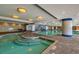 Relaxing indoor pool area featuring columns, a hot tub, and plenty of seating around the area at 603 S Ocean Blvd. # 1205, North Myrtle Beach, SC 29582