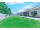 Expansive backyard with lush green lawn, a screened porch, and a white picket fence at 617 Chiswick Dr., Conway, SC 29526