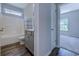 Bright bathroom with a shower-tub combo and sleek vanity, connected to another room at 617 Chiswick Dr., Conway, SC 29526