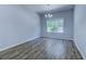 Bright dining room featuring wood floors, a window, and a modern chandelier at 617 Chiswick Dr., Conway, SC 29526