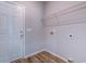 Laundry room with wood floors and overhead wire rack at 617 Chiswick Dr., Conway, SC 29526