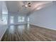 Spacious living room with hardwood floors, modern lighting, and large windows at 617 Chiswick Dr., Conway, SC 29526