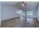 The living room features hardwood floors, fan, and lots of natural light at 617 Chiswick Dr., Conway, SC 29526