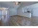 The living room features hardwood floors, neutral paint, and is open to the kitchen at 617 Chiswick Dr., Conway, SC 29526
