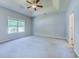 Spacious primary bedroom with tray ceiling, ceiling fan, and a large window for natural light at 617 Chiswick Dr., Conway, SC 29526
