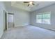 Bright primary bedroom featuring soft carpet, a tray ceiling and large window offering lovely outdoor views at 617 Chiswick Dr., Conway, SC 29526