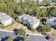 Aerial view of condo building surrounded by trees, with a parking lot and landscaped grounds at 6253 Catalina Dr. # 534, North Myrtle Beach, SC 29582