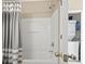 Bathroom featuring a white tub with shower, gray striped shower curtain, and a laundry closet at 6253 Catalina Dr. # 534, North Myrtle Beach, SC 29582