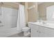 Bright bathroom featuring a tub with shower, white shower curtain, toilet, white vanity, and large mirror at 6253 Catalina Dr. # 534, North Myrtle Beach, SC 29582