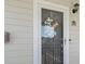 Charming entrance featuring a welcome sign, decorative wreath, and a secure screen door at 6253 Catalina Dr. # 534, North Myrtle Beach, SC 29582