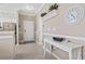 Hallway featuring tile floors, a console table, and a mounted wall clock at 6253 Catalina Dr. # 534, North Myrtle Beach, SC 29582