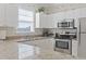 Well-lit kitchen with granite countertops, stainless steel appliances and white cabinets at 6253 Catalina Dr. # 534, North Myrtle Beach, SC 29582