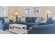 Cozy living room with comfortable blue seating, a white coffee table, and nautical-themed artwork at 6253 Catalina Dr. # 534, North Myrtle Beach, SC 29582