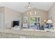 Living room with vaulted ceiling, ceiling fan, chandelier, and access to the balcony at 6253 Catalina Dr. # 534, North Myrtle Beach, SC 29582