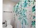 Bathroom showcasing a floral shower curtain, toilet, and a towel rack at 639 Waterway Village Blvd # 14-I, Myrtle Beach, SC 29579