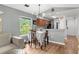 Dining area with hardwood floors, a table with seating, and a view of the kitchen at 639 Waterway Village Blvd # 14-I, Myrtle Beach, SC 29579