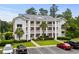 Three-story condo building featuring multiple balconies, green landscaping, and ample parking at 639 Waterway Village Blvd # 14-I, Myrtle Beach, SC 29579
