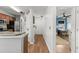 Hallway with hardwood floors leading to a room with a ceiling fan and a kitchen on the left at 639 Waterway Village Blvd # 14-I, Myrtle Beach, SC 29579