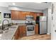 Well-equipped kitchen featuring wood cabinets, stainless steel appliances and granite countertops at 639 Waterway Village Blvd # 14-I, Myrtle Beach, SC 29579