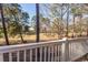 Tree-lined backyard view from a white balcony overlooking a lush, inviting natural setting at 690 Riverwalk Dr. # 201, Myrtle Beach, SC 29579