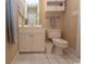 Bright bathroom with white vanity, sink, toilet, and vanity cabinet, plus a white tile floor at 690 Riverwalk Dr. # 201, Myrtle Beach, SC 29579