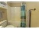 Neutral bathroom featuring tub, blue shower curtain and matching towels for a coordinated and tranquil space at 690 Riverwalk Dr. # 201, Myrtle Beach, SC 29579