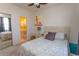 Light-filled bedroom with queen bed, coordinating floral bedding, with an ensuite bathroom at 690 Riverwalk Dr. # 201, Myrtle Beach, SC 29579