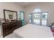 Bedroom features a dresser with a large mirror and a door to the exterior at 690 Riverwalk Dr. # 201, Myrtle Beach, SC 29579