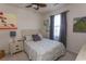 Well-lit bedroom with a queen-size bed, wooden headboard, ceiling fan, and soothing wall art at 690 Riverwalk Dr. # 201, Myrtle Beach, SC 29579