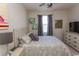 Comfortable bedroom features a queen-sized bed, ceiling fan, dresser, wall art, and neutral carpet at 690 Riverwalk Dr. # 201, Myrtle Beach, SC 29579