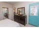 Bright bedroom with a dresser, ensuite bathroom and exterior exit at 690 Riverwalk Dr. # 201, Myrtle Beach, SC 29579