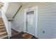 Apartment front door with stairs and a 'Happy Home' welcome mat at 690 Riverwalk Dr. # 201, Myrtle Beach, SC 29579