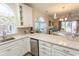 Bright, open kitchen with white cabinets, stainless steel appliances, and direct access to the dining and living areas at 690 Riverwalk Dr. # 201, Myrtle Beach, SC 29579