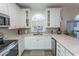 Bright kitchen featuring white cabinets, modern appliances, granite countertops, and a charming window at 690 Riverwalk Dr. # 201, Myrtle Beach, SC 29579