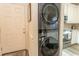 Modern stackable washer and dryer, adjacent to the doorway and next to the kitchen at 690 Riverwalk Dr. # 201, Myrtle Beach, SC 29579