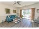 Comfortable living room features a sofa, wood floors, and sliding glass doors to a patio at 690 Riverwalk Dr. # 201, Myrtle Beach, SC 29579