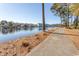 Scenic water view with walking path and waterfront condos with surrounding trees at 690 Riverwalk Dr. # 201, Myrtle Beach, SC 29579
