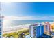 Amazing balcony view of the beautiful ocean and beach with several inviting patio chairs at 7100 N Ocean Blvd. # 1421, Myrtle Beach, SC 29572