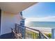 A gorgeous balcony view features inviting patio furniture and stunning ocean scenery at 7100 N Ocean Blvd. # 1421, Myrtle Beach, SC 29572