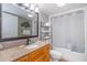 Bathroom with vanity, large mirror, decorative fish art, and a tub and shower combination at 7100 N Ocean Blvd. # 1421, Myrtle Beach, SC 29572